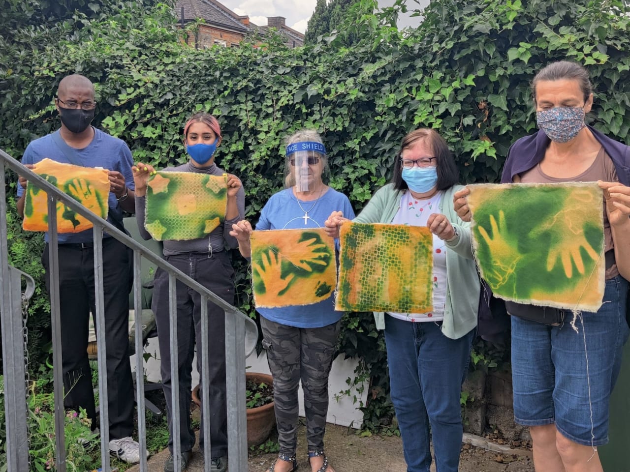 Picture of people holding one painting each